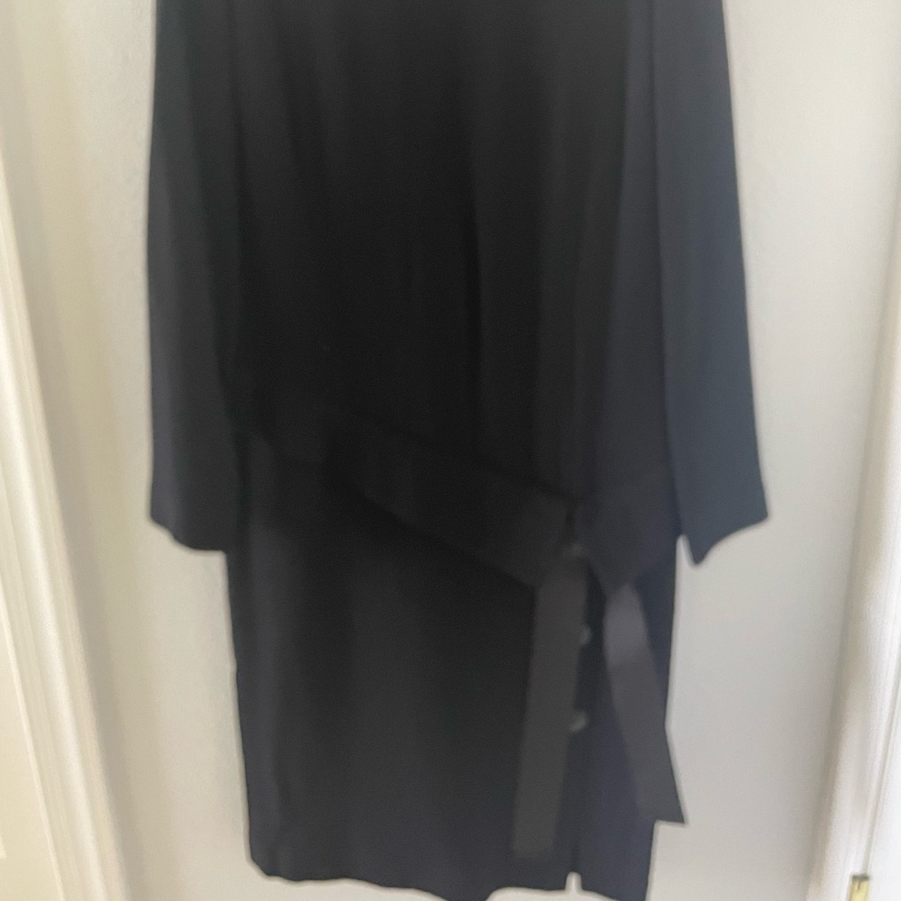 Classic mock turtleneck collar fully lined.  Drop waist with wonderful detail